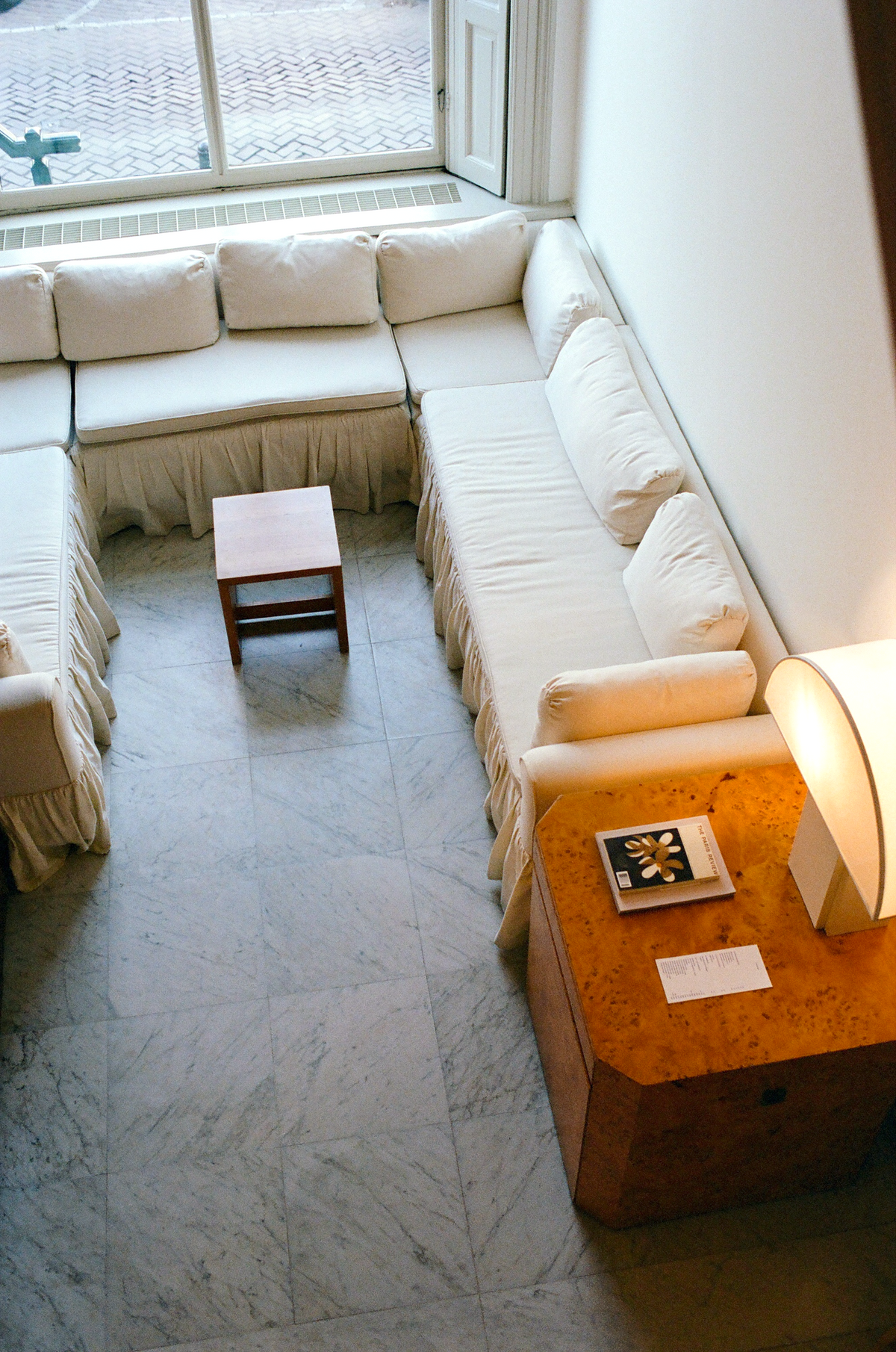 White sofas and a marble floor in the living room of the CARMEN house in Amsterdam