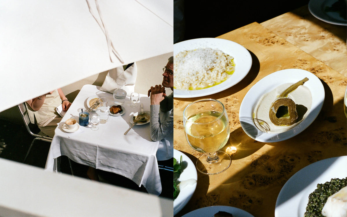 Lunch in the sun at the CARMEN kitchen: plates of food and a glass of white wine